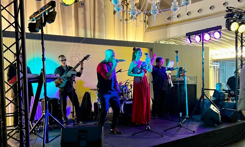 Vibrant Calle Habana Band performing live on stage with colorful lighting, capturing ambient nightlife energy and musical entertainment in a stylish venue.